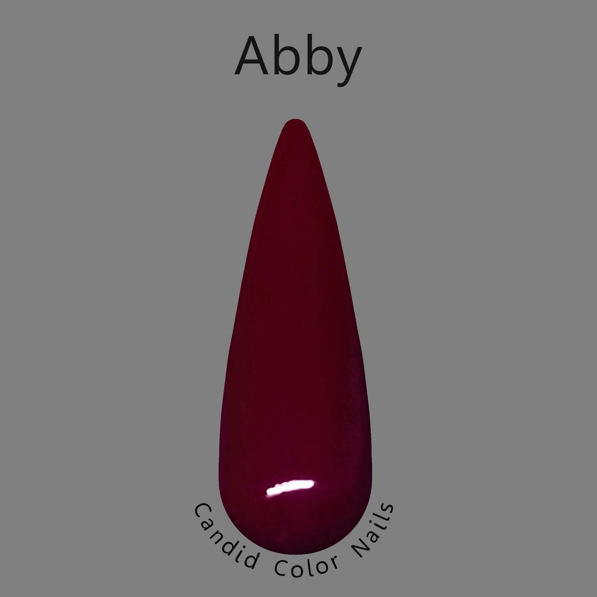 A finger nail swatch with  a dark red opaque dip powder.